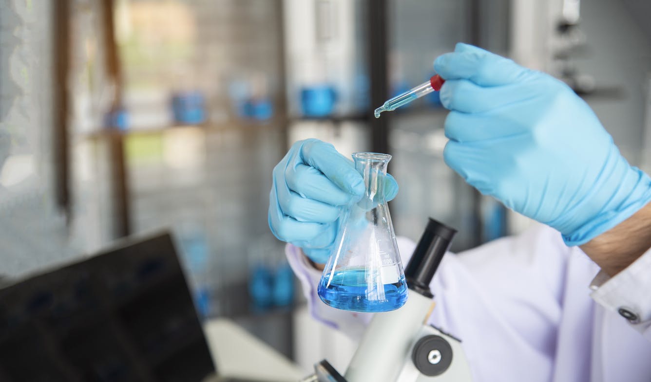 scientist mixing chemical compounds stock image