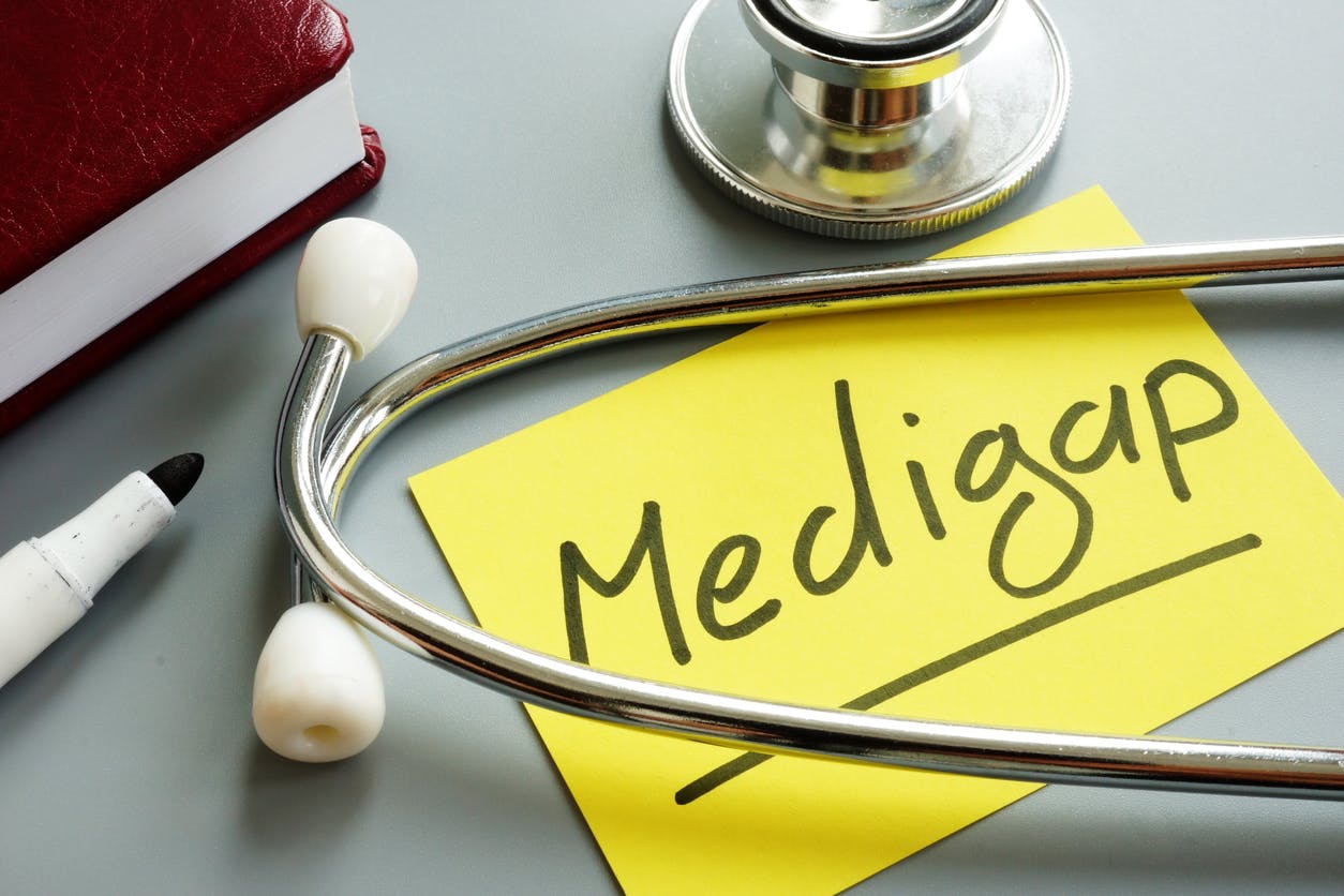 Medigap on a post-it note surrounded by a stethoscope stock image