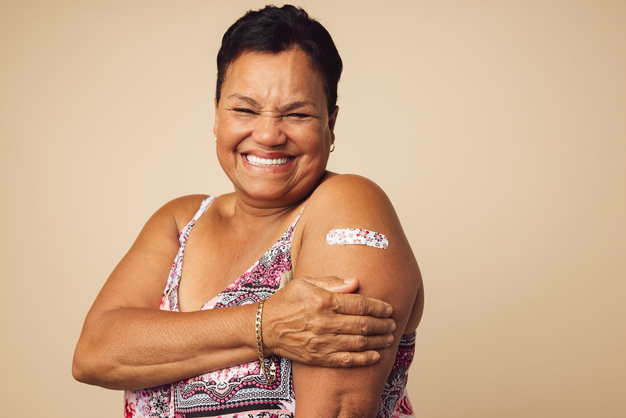 Senior woman smiling after vaccination stock photo