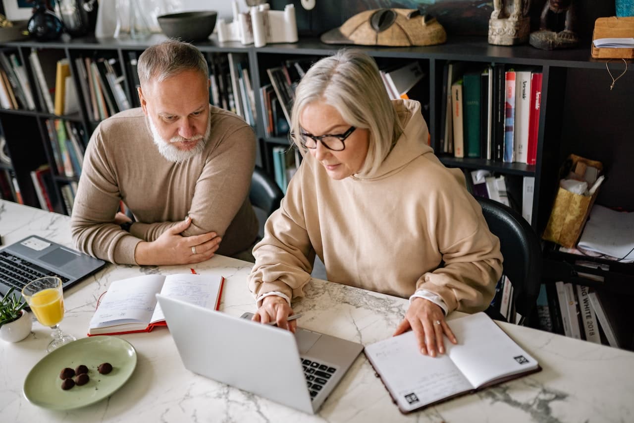 Senior couple working at a computer stock image