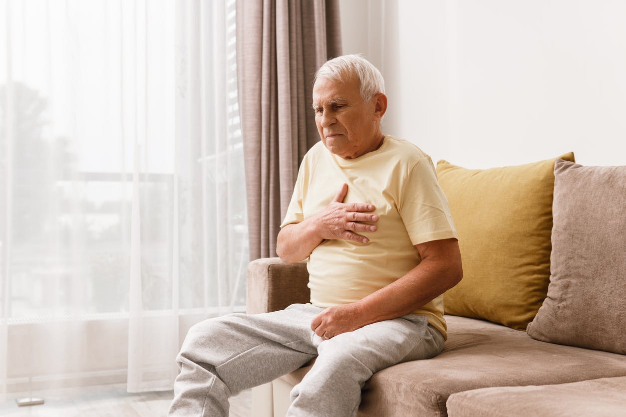 senior man experiencing discomfort stock image