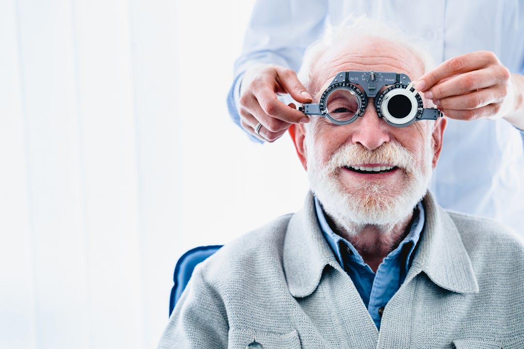 Senior man receiving care from an optometrist stock photo