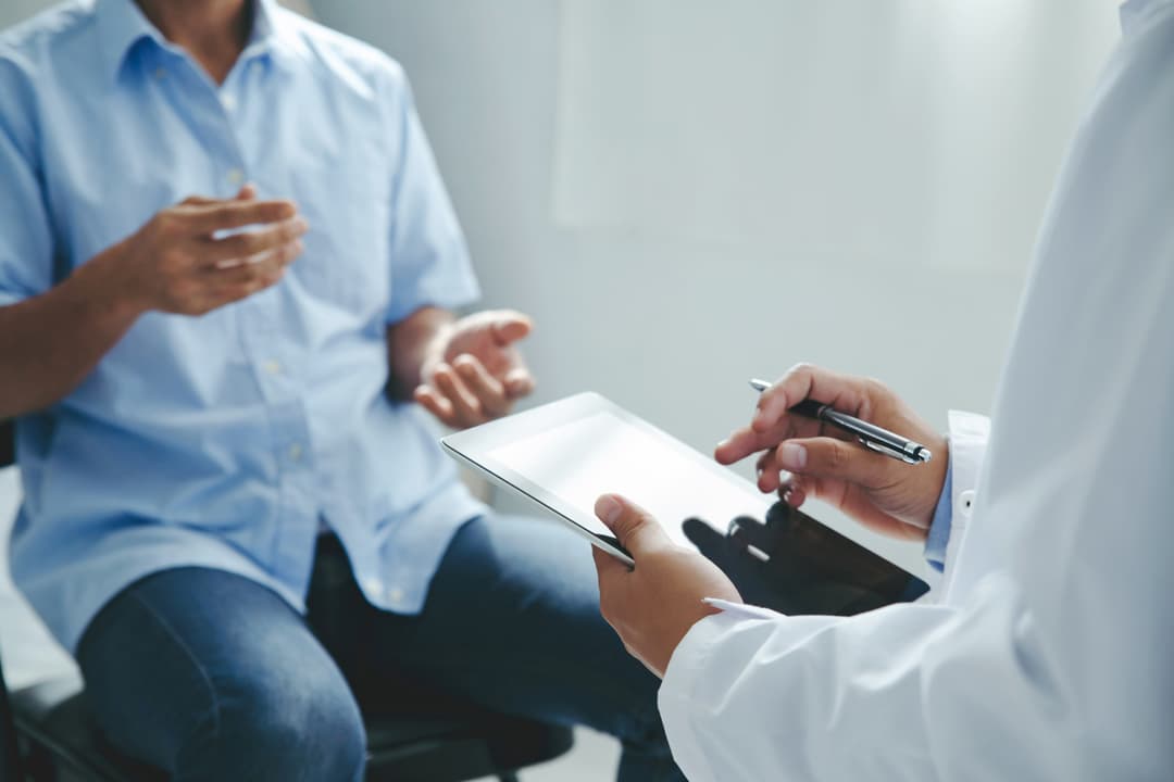 Doctor talking to patients are explaining the treatment of a patient's illness stock photo