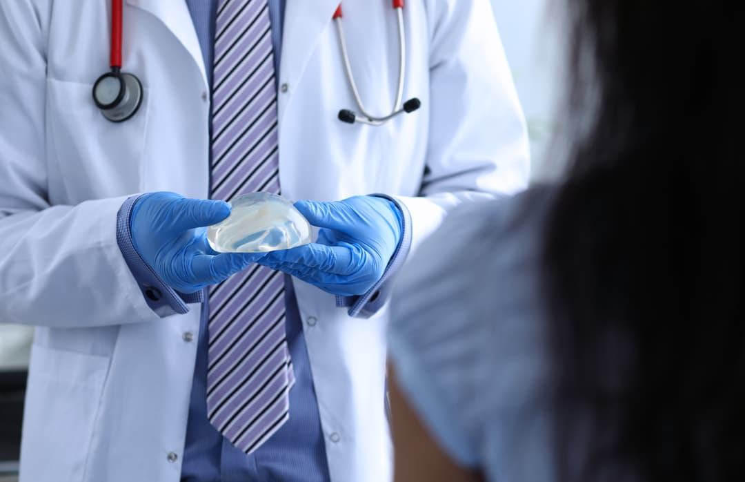Plastic surgeon handles a silicon implant