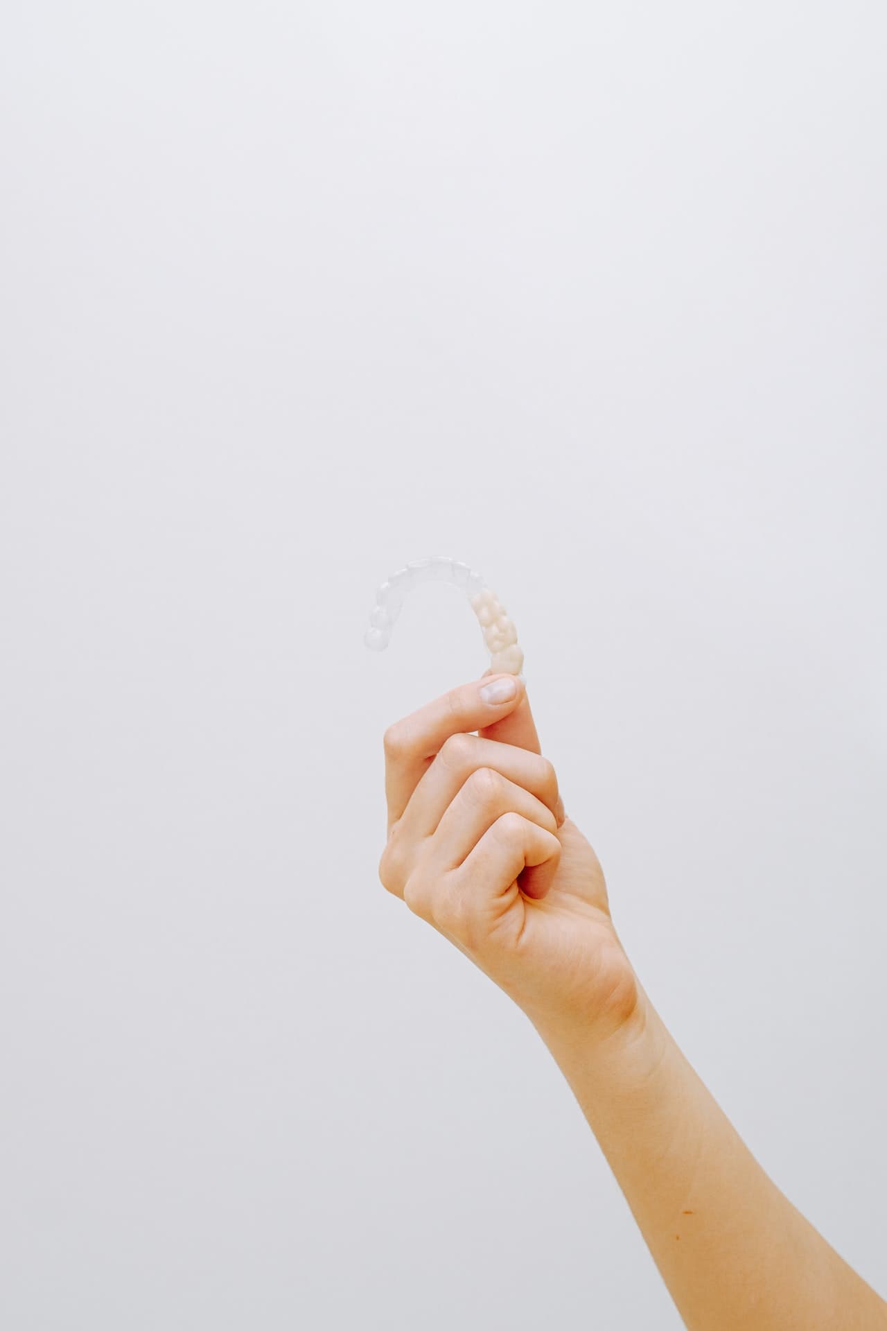 hand holding up Invisalign stock photo