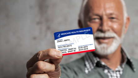 senior man holding out his medicare card stock image