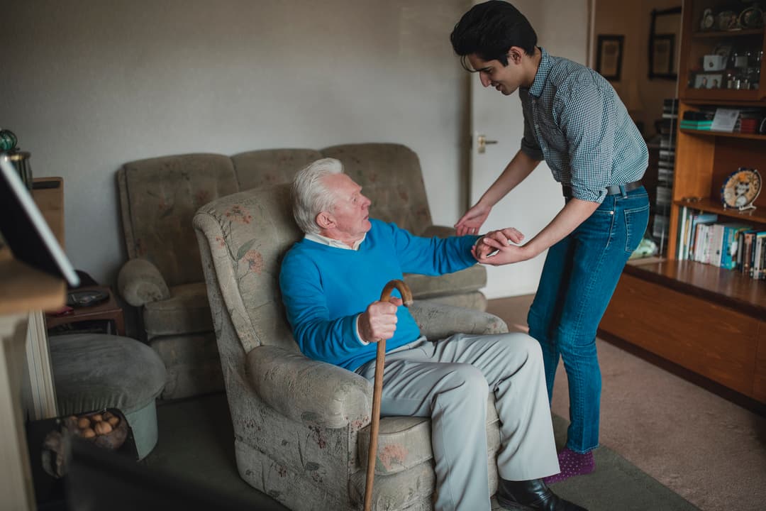 Teenager Helping his Grandfather at Home stock photo